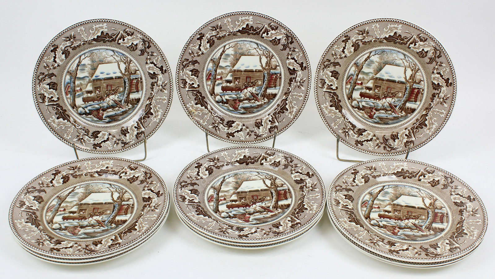 12 Johnson Brothers Historic America Plates: Set of 12 Johnson Brothers English porcelain dinner plates with transfer decorated scenes depicting "Thanksgiving-Frozen Up", with turkey, horse and sleigh in winter mill scene 9.5" -overall good cond