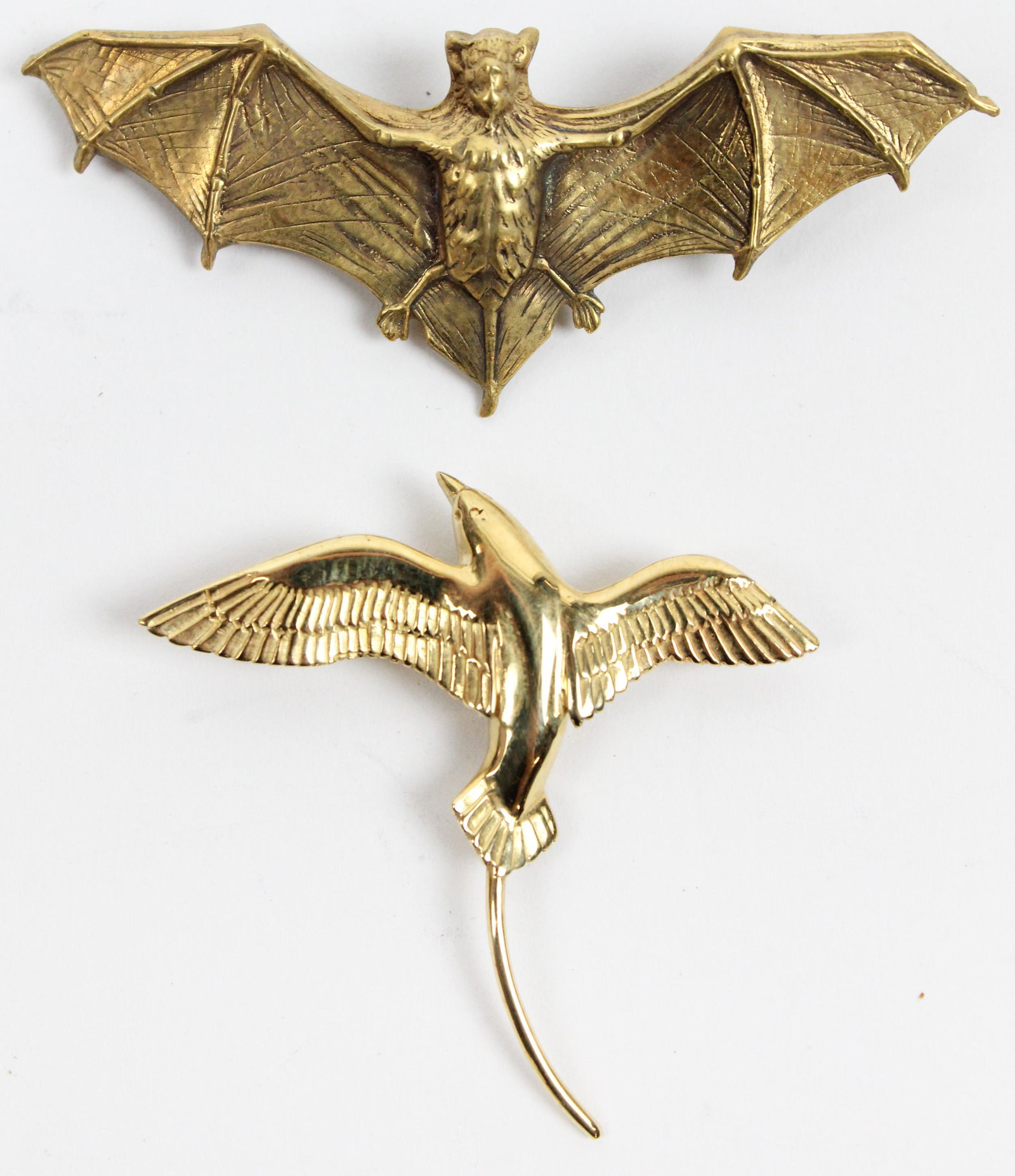 Two figural Yellow gold pins: A 14k yellow gold bird / gull pin. 1 1/2" long 6.4 grams - with a tests 10k yellow gold bat figural pin. 2 1/2" wide, 4.4 grams.