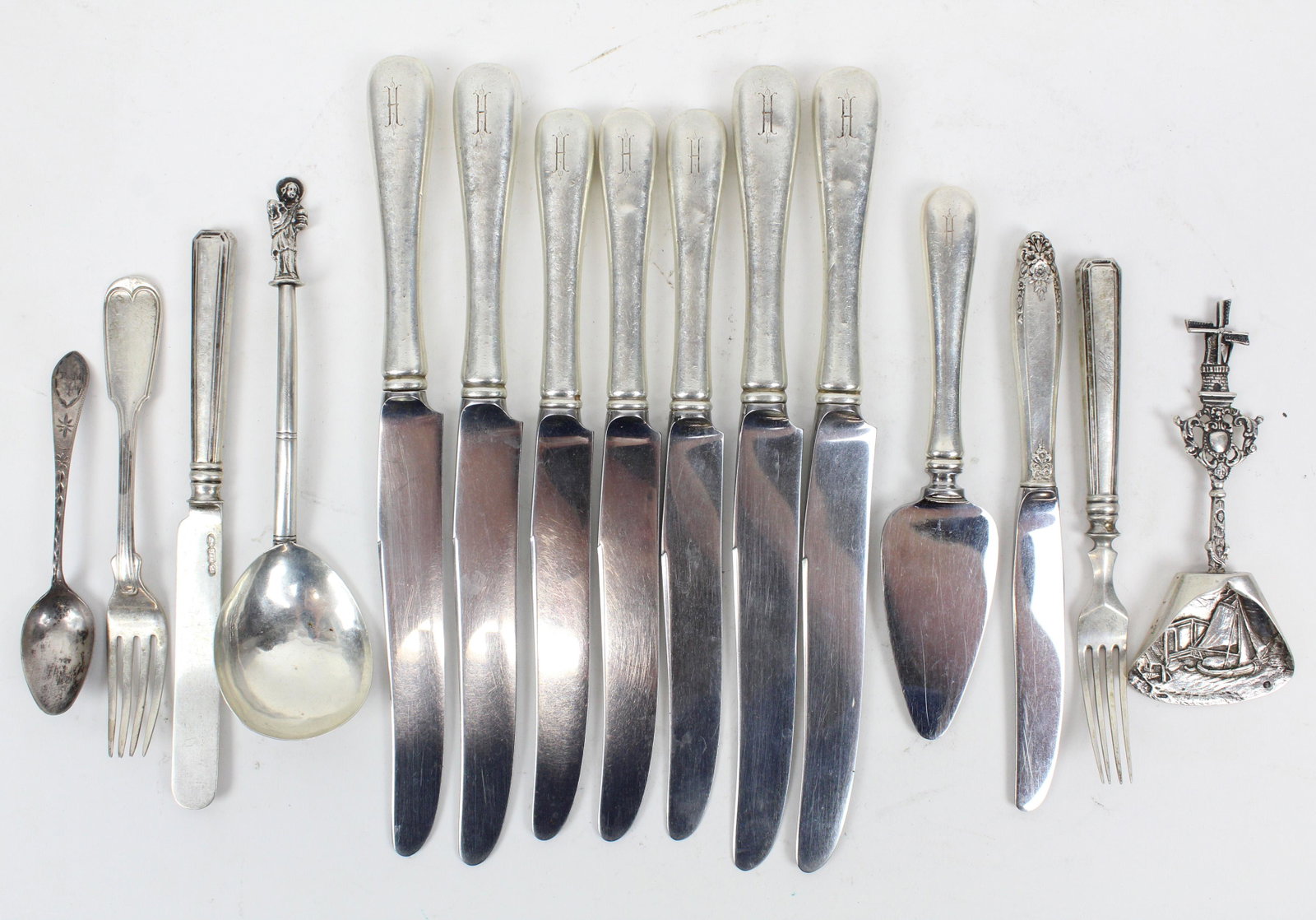 Group of 15 pcs. Assorted Silver Flatware: Group of 15 pcs. assorted silver flatware including 8 Gorham sterling handled knives (w/cheese spreader), Dutch windmill scoop, hallmarked 2 pc. youth cutlery set, fiddle thread fork, apostle handle s