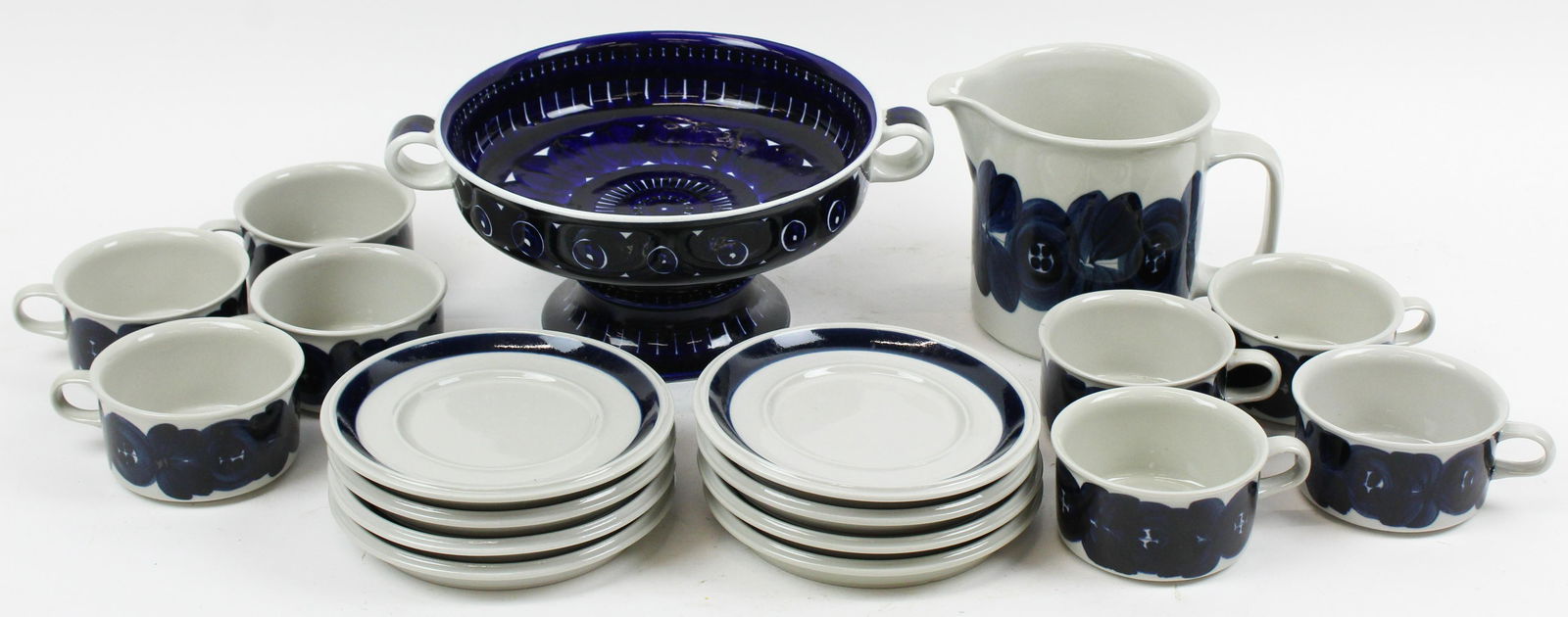 18 pcs. Arabia Finland Pottery Tableware: 18 pcs. Arabia of Finland stoneware pottery tableware including "Valencia" pattern footed compote bowl, and "Blue Anemone" designed by Ulla Procope pitcher and 8 cups and saucers ht. 2"-5.5" -sold to