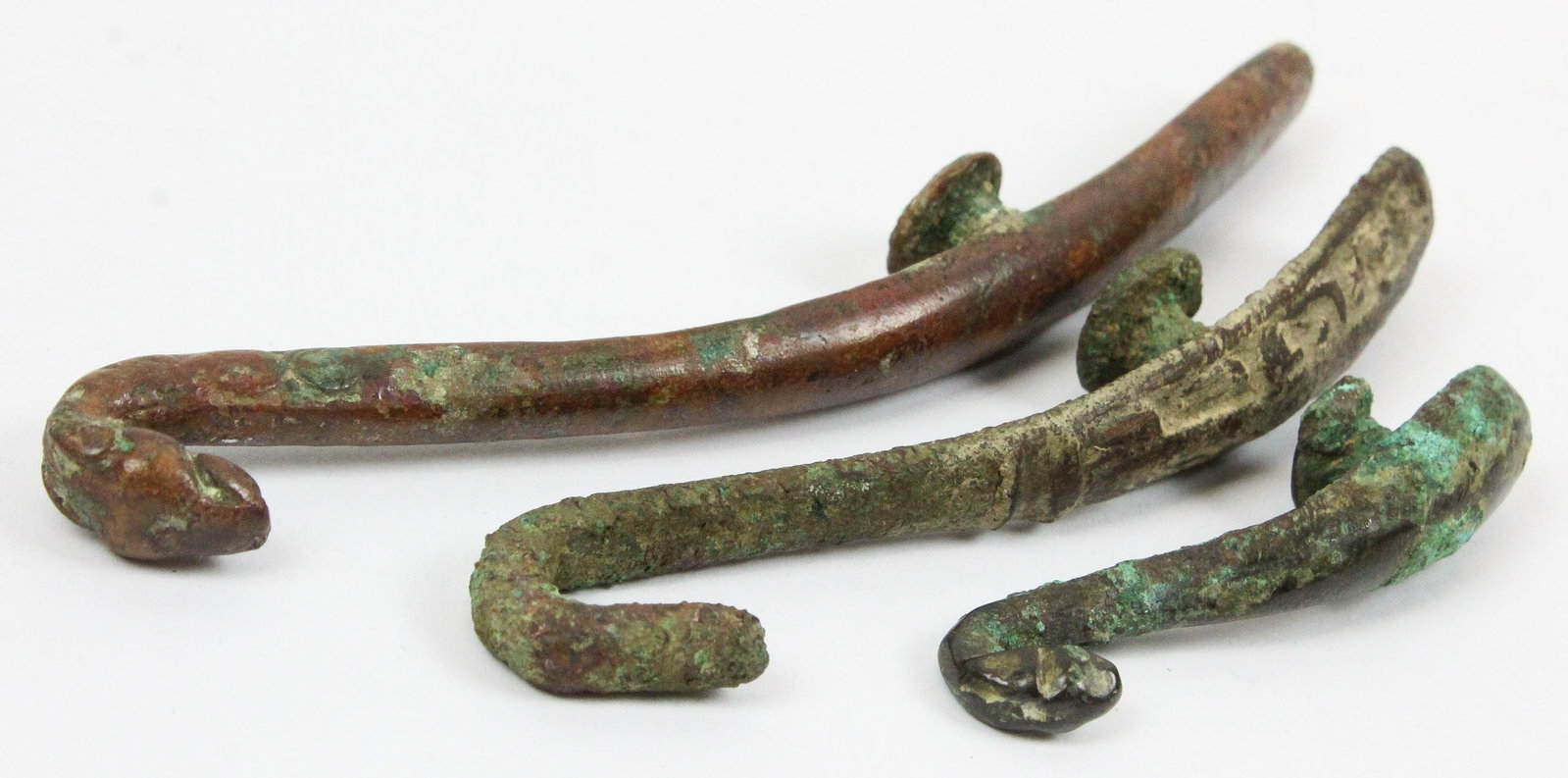 Chinese Han Dynasty Bronze Belt Hooks: Three Chinese Han Dynasty (206 BC- 220 AD) bronze belt hooks lengths 2 1/4" to 5", ex Iris Love
