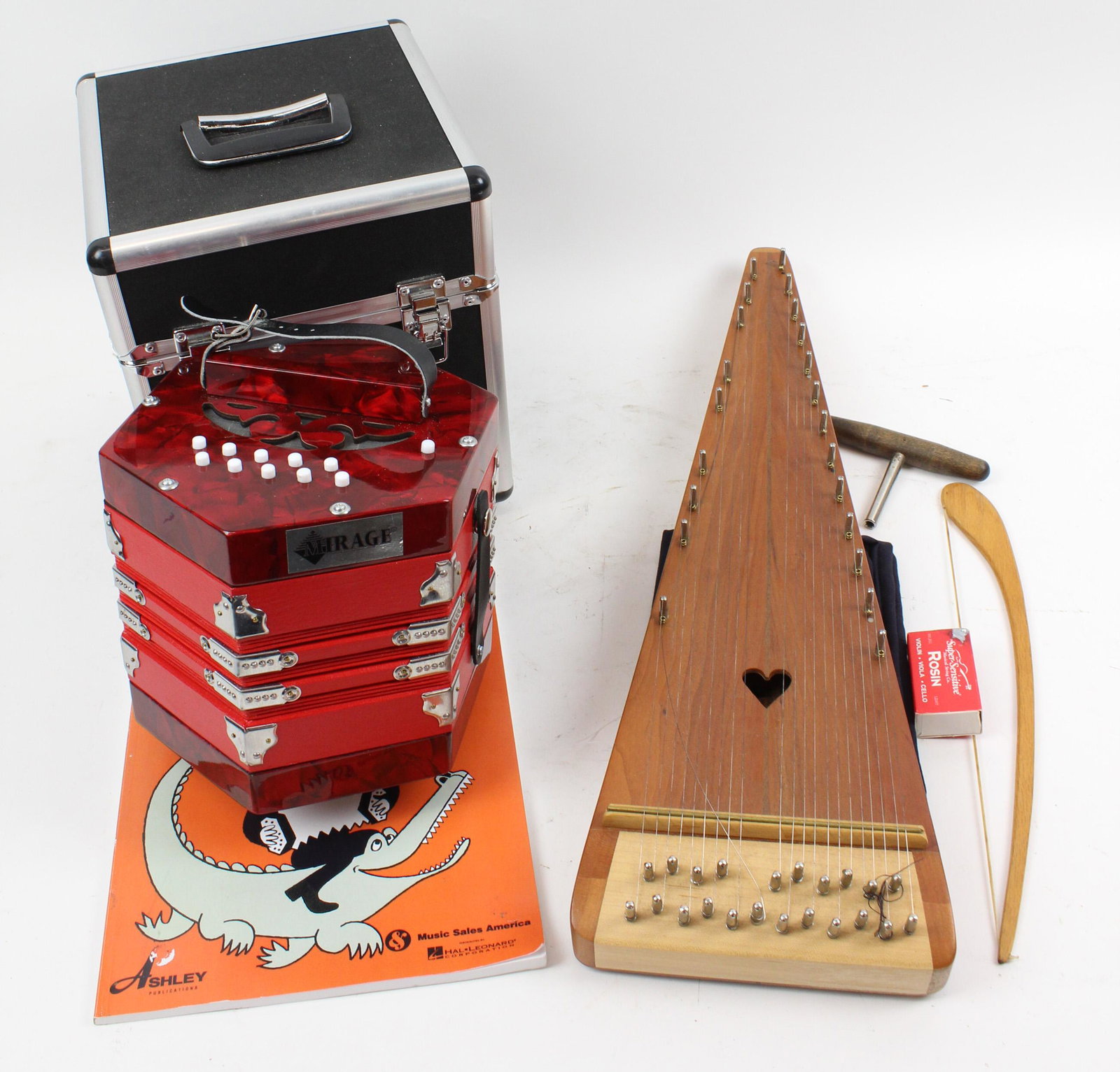 Concertina and Mountain Made Music Bowed Psaltery: Cased Mirage concertina with instructional book, and Mountain Made Music Nashville, Indiana custom cherry bowed psaltery string instrument 23.5" x 7.5" -sold to benefit the Brattleboro Area Hospice