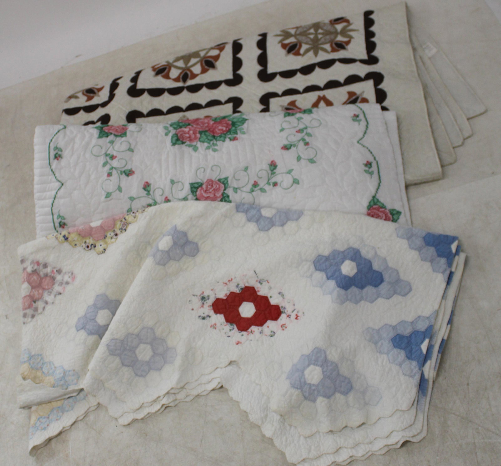 Group of 3 Handmade Quilts: Two contemporary handmade quilts, one large queen sized ca. 1970 "Tulip Sampler" brown and rust applique quilt by Helen McCausland 94.5' x 110.5", and rose embroided quilt 85" x 85", accompanied by a 
