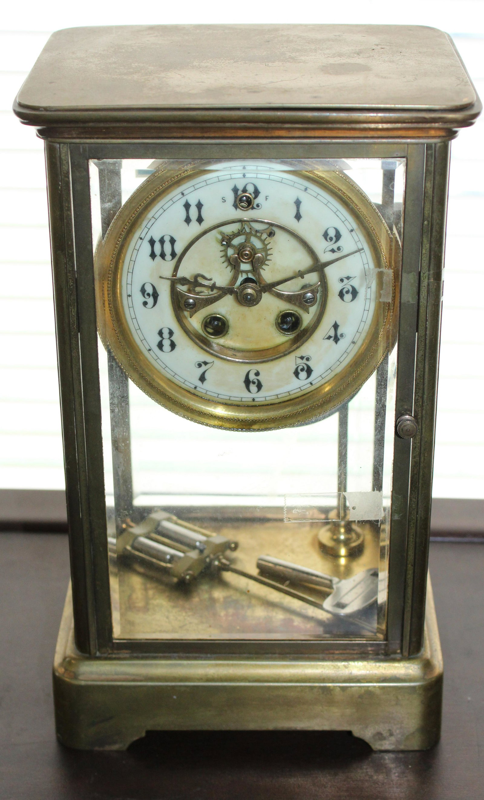 Gilbert Brass Crystal Regulator Shelf Clock: ca. 1910 Gilbert blrass and beveled glass crystal regulator shelf clock with enameled dial and visual escapement - as found; top loose, back door with crack and loose frame, untested 10.5" x 6.5