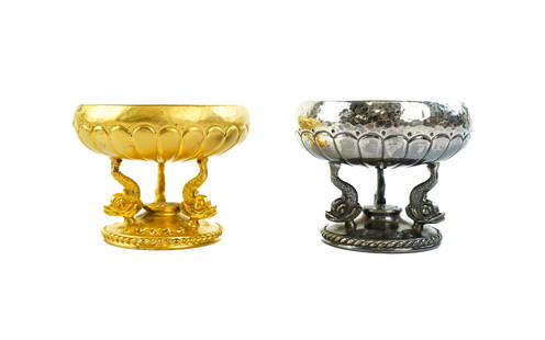 Two Ilias Lalaounis Master Salts: Two Ilisas Lalaounis silver master salts. One in hammered finish, triple dolphin feet marked on bottom, 2 1/2", in original box. Second master salt in gilt finish, triple dolphin feet, signed on botto