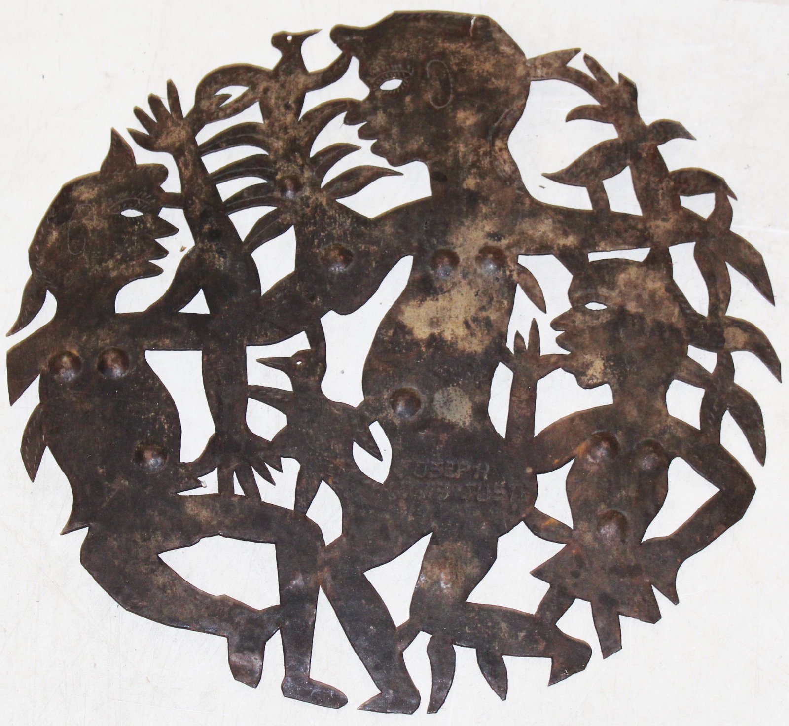 Joseph Louis Juste (HA 1940-1989): Joseph Louis Juste (Haitian 1940-1989) Steel cutout wallhanging with anthropomorphic figures and birds approx 24" diameter signed by Artist