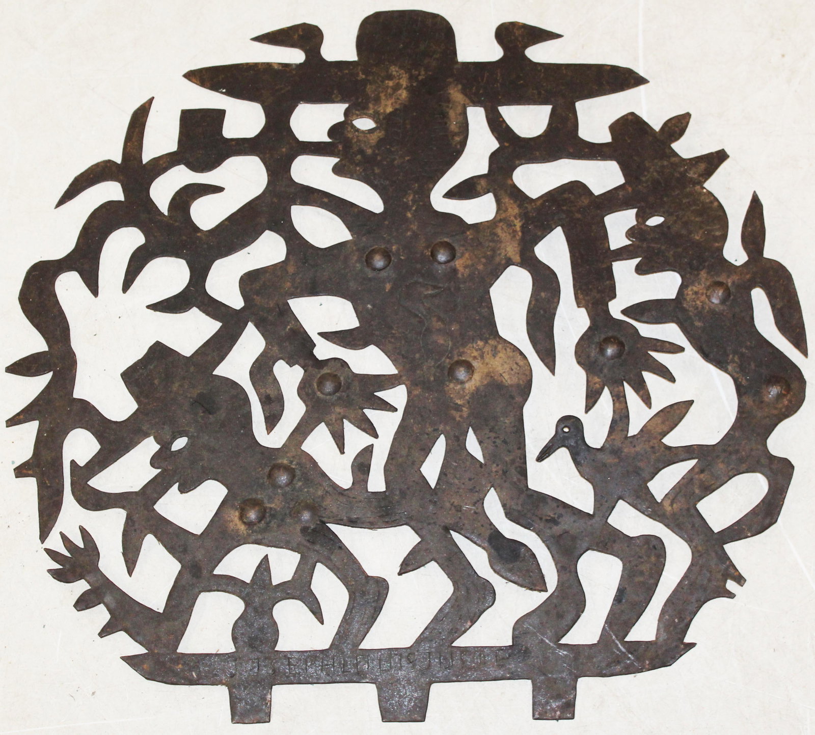 Joseph Louis Juste (HA 1940-1989): Joseph Louis Juste (Haitian 1940-1989)Steel cutout wallhanging with Anthropomorphic figures and birds approx 24" diameter signed by artist