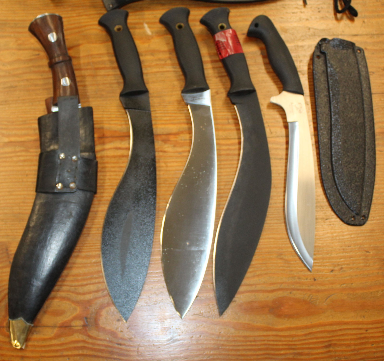 Five Contemporary Kukri/ Ghurka Knives: Five Contemporary Kukri or Ghurka Knives including Pacific Cutlery Bushmaster Balisong Model 670 10" blade 15" overall ; Three Cold Steel All Terrain Choppers Carbon V Knives one in stainless 12" blad