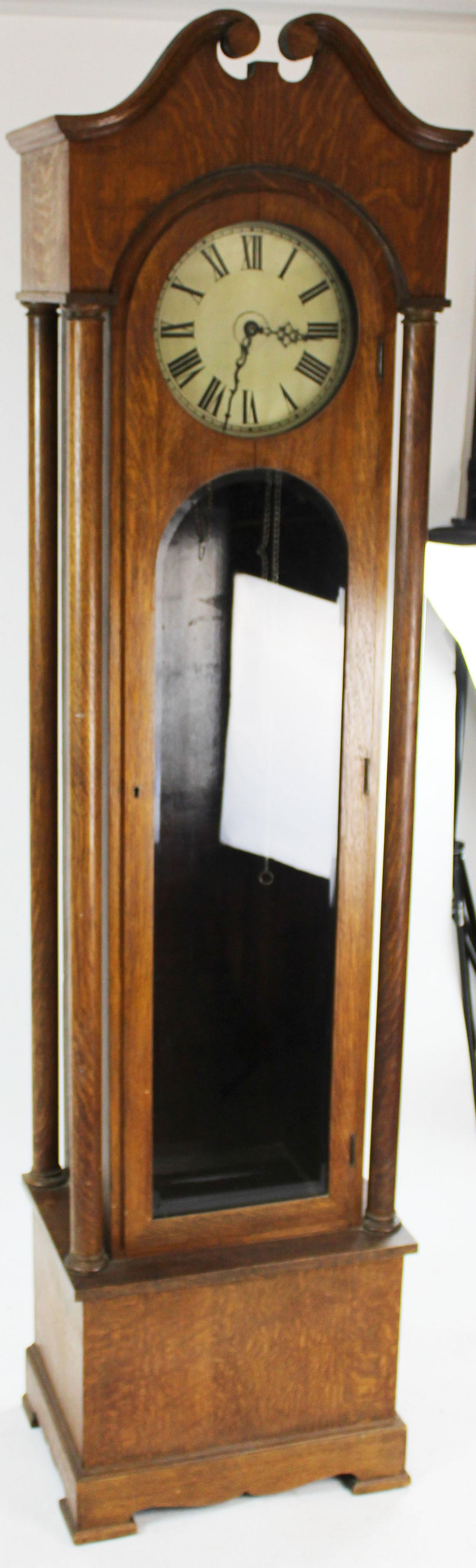 ca. 1910 Quartersawn Oak Tall Case Clock: ca. 1910 Quartersawn oak tall case "grandfather" clock with silvered roman numeral dial, broken arch pediment top over turned neoclassical columns and beveled glass door, brass works, maker unknown 86