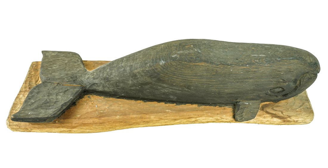Carved Sperm Whale: Folk art 20th c carving of a Sperm Whale, top down view on plaque in light black surface. Carved by Ron Gallant Stowe, VT. In the manor of Clark Vorrhees. 30" long.