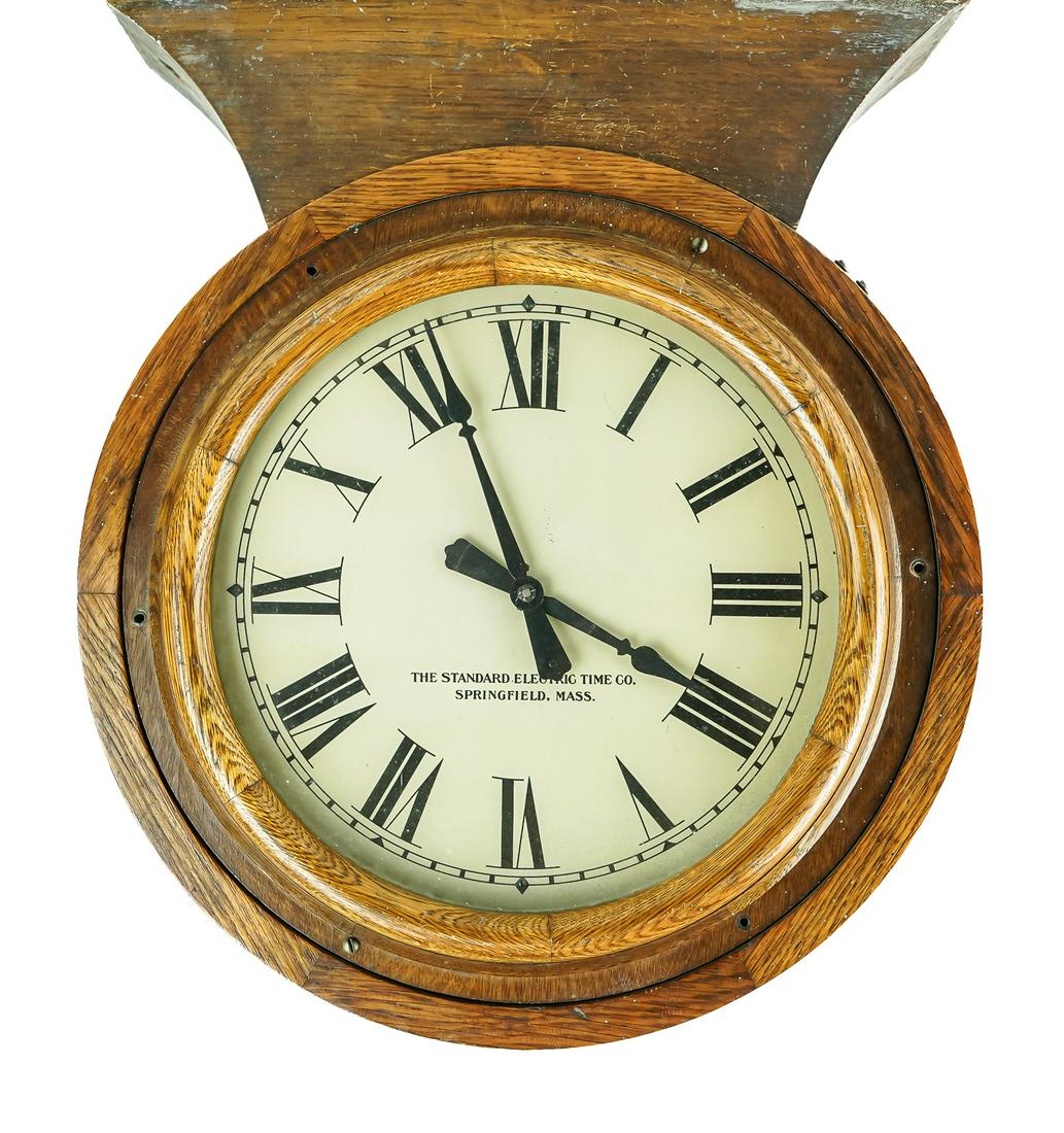 Standard Electric Time Co. Oak Double Sided Clock: ca. 1910 Standard Electric Time Co. Springfield, Mass. oak circular double-sided factory or station gallery clock with mounting bracket to affix to ceiling or wall, appears to be an electric slave clo