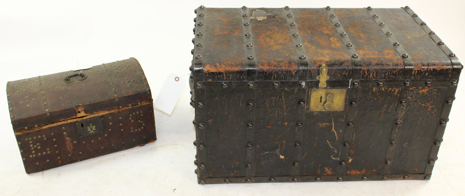 Two 19th c. Leather Covered Trunks: Two 19th century leather covered trunks including small dome top box and Civil war era trunk with large brass tacks 18" x 30" x 18", 11"x 18" x 9" -some splitting and losses