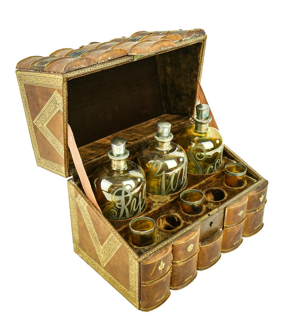 Ca. 1900 Leatherbound Book Liquor Set: Ca. 1900 boxed liqueur set. Exterior of 5 leather bound books hinged in back, interior with three silver overlay flashed deep yellow bottles "Rye", "Scotch", "Gin". With 3 matching shot glasses. Missi