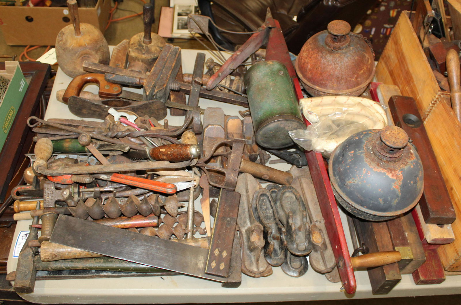 Large Collection of Antique and Vintage Tools: Large collection of antique and vintage tools including block planes, levels, mahogany and brass square, malletts, hatchet, pipe wrenches, folding rules, shoe lasts, sludge pots, etc.