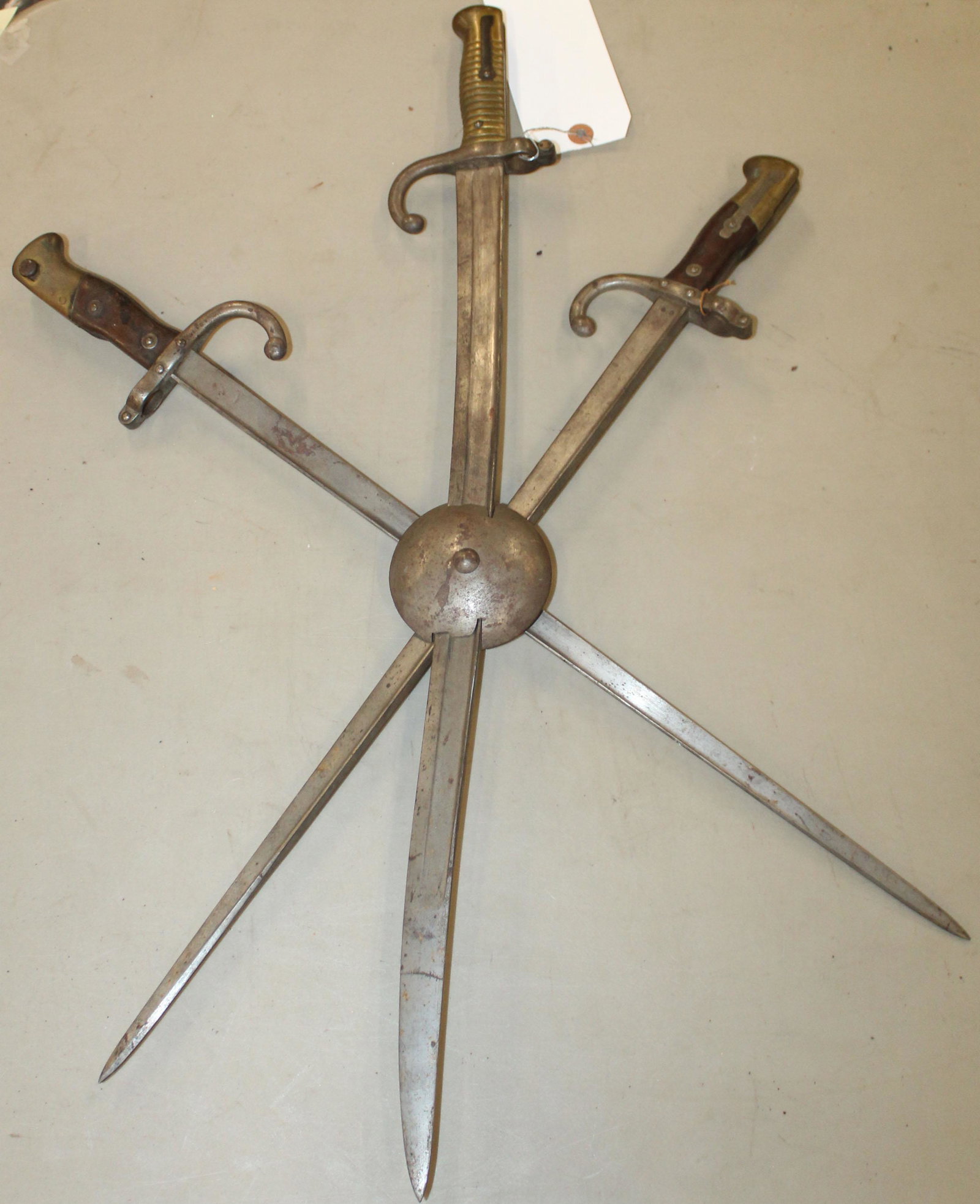 Three French St Etienne bayonets: Three French St Etienne Bayonets set with screw behind a rondel as a display.