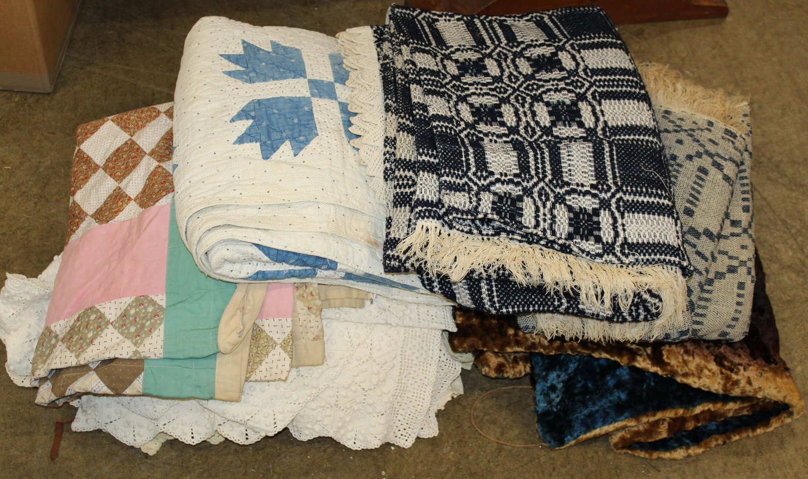 Lot of Vintage Needlework Bed and Table Linens: Lot of vintage needlework bed and table linens including 2 blue and white homespun coverlets, 2 patchwork quilts, crocheted bedspreads, napkins, doilies, velour sleigh robe etc.