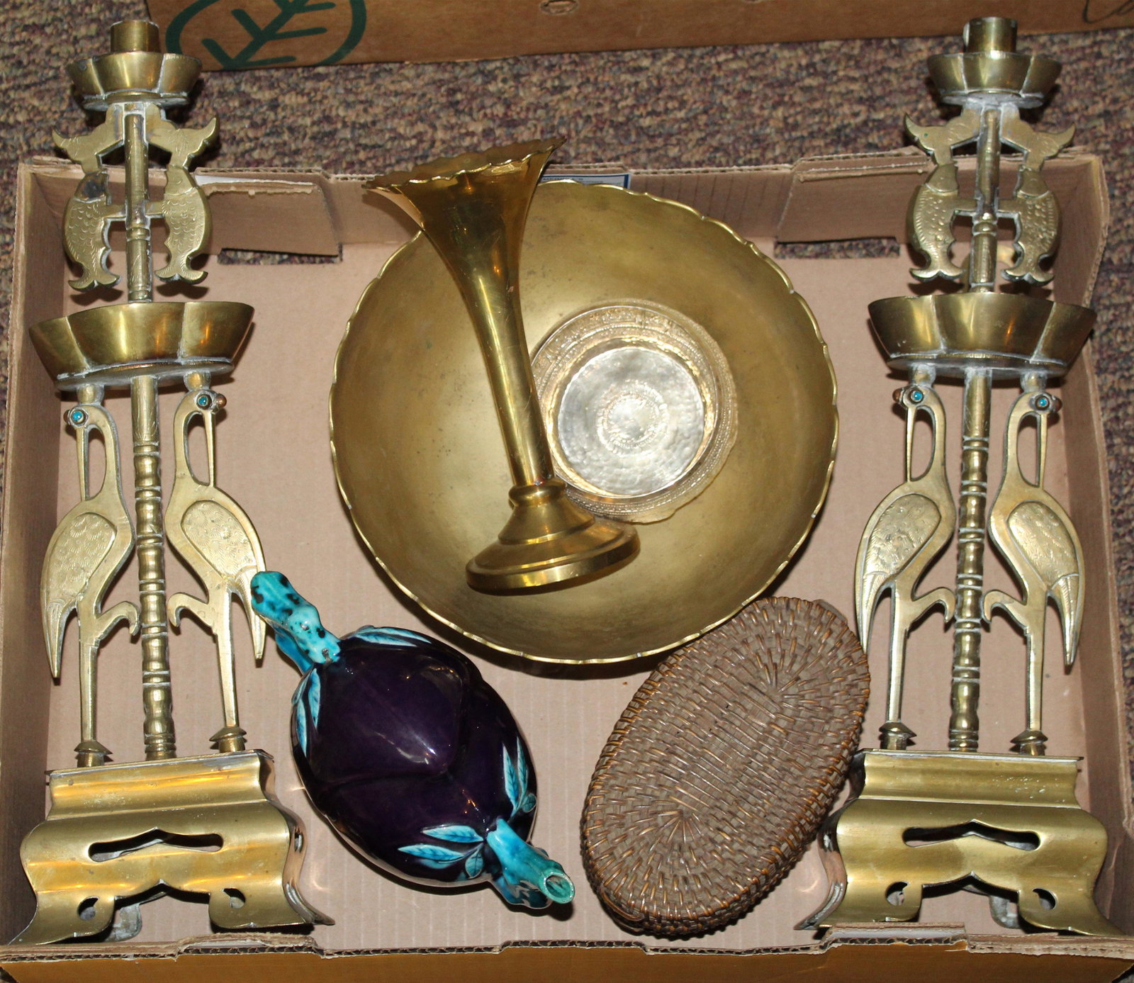 Asian Brass, Silver, and Porcelain Objects: Lot of Asian decorative objects including ca. 1920 Chinese porcelain plum form puzzle teapot, pair of figural bird and fish decorated candlesticks, Cambodian silver repousse bowl, small oval wicker ba