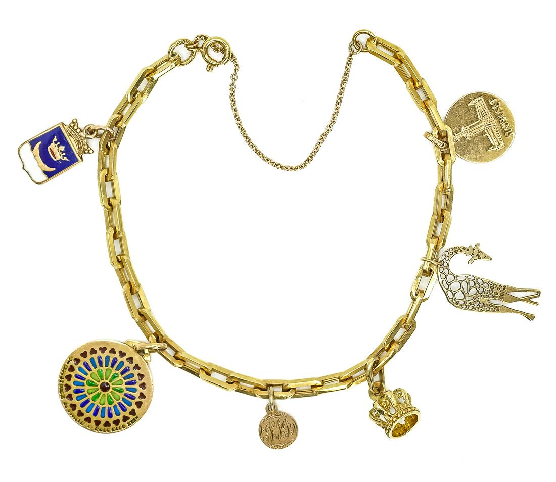 18k Yellow Gold Charm Bracelet: 18k yellow gold charm bracelet with 6 charms 10k and 14k. 9.9 grams.