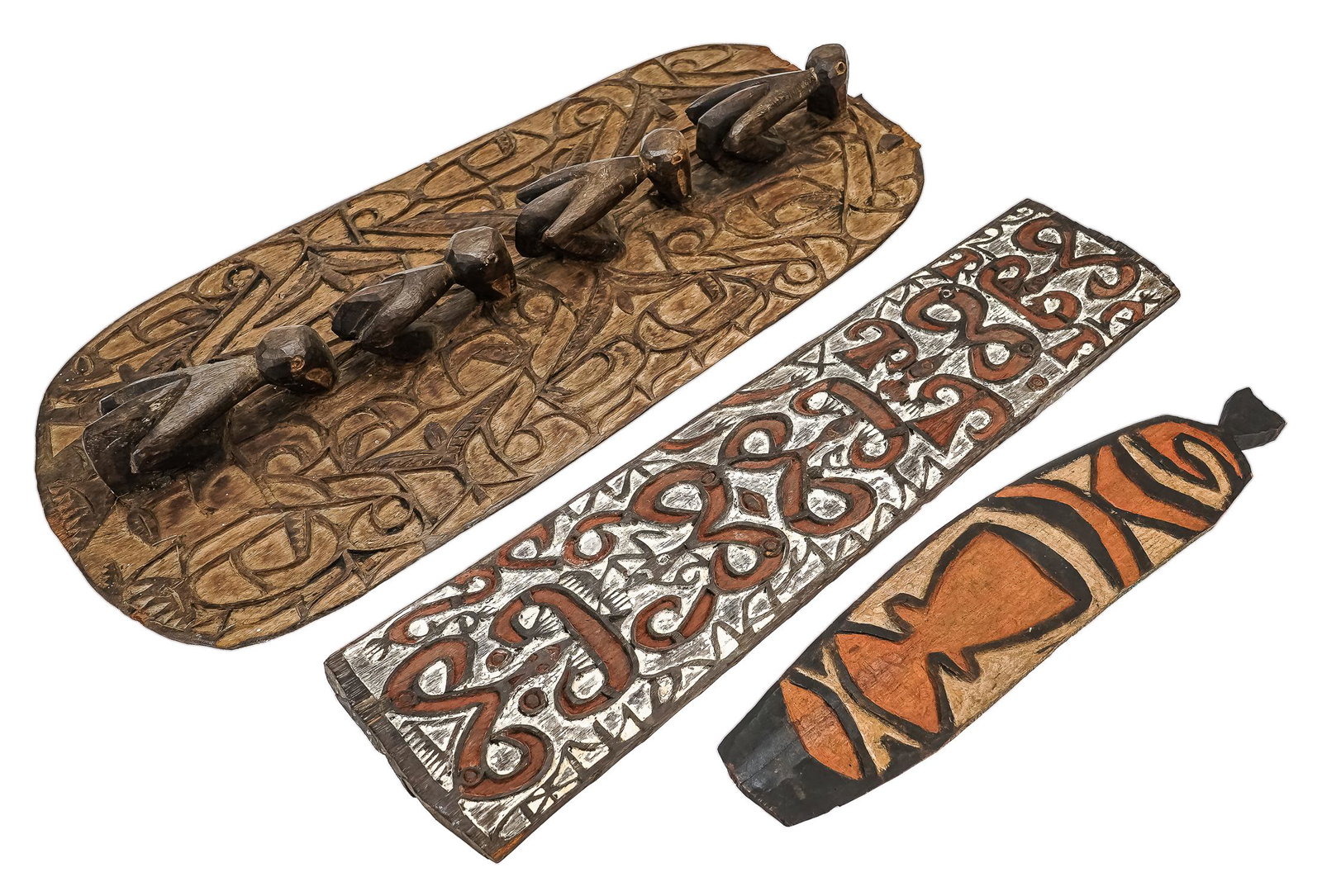 Asmat Wall Panels and Bullroarer: Lot consists of one painted and carved wall panel, one carved wall panel with birds, and one bullroarer instrument. 25"x6.25", 27"x12.75", and 18"