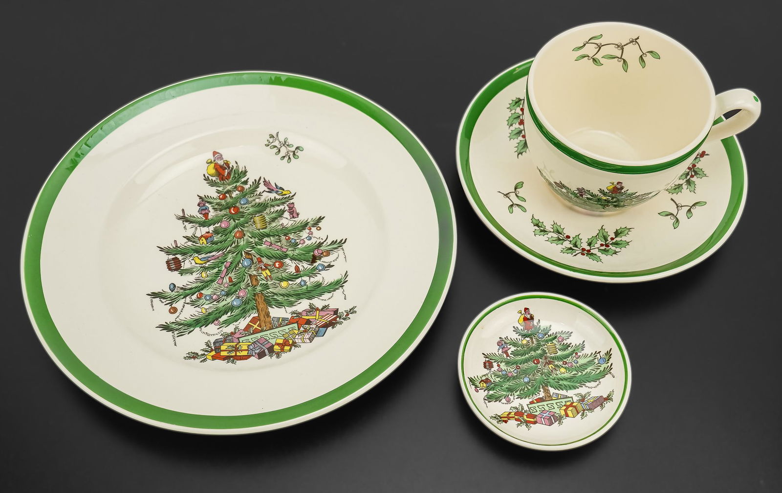 Spode Christmas Tree China, Ray Harm Plates: 30 pcs. of Spode English pottery "Christmas Tree" festive holiday tableware including dinner plates, cups and saucers, candlesticks, pitcher, placemats, coasters, etc. accompanied by 9 Spode fine bone