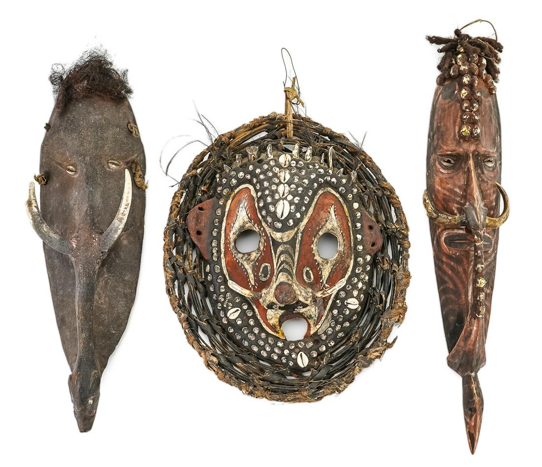 Three Papua New Guinea Masks: Two Mwai masks: one with shell, nose ring, human hair, natural pigments. One with human hair, cowrie shell inlaid eyes, bone nose ring. One turtle shell mask with bone, shell, teeth, woven border, fea