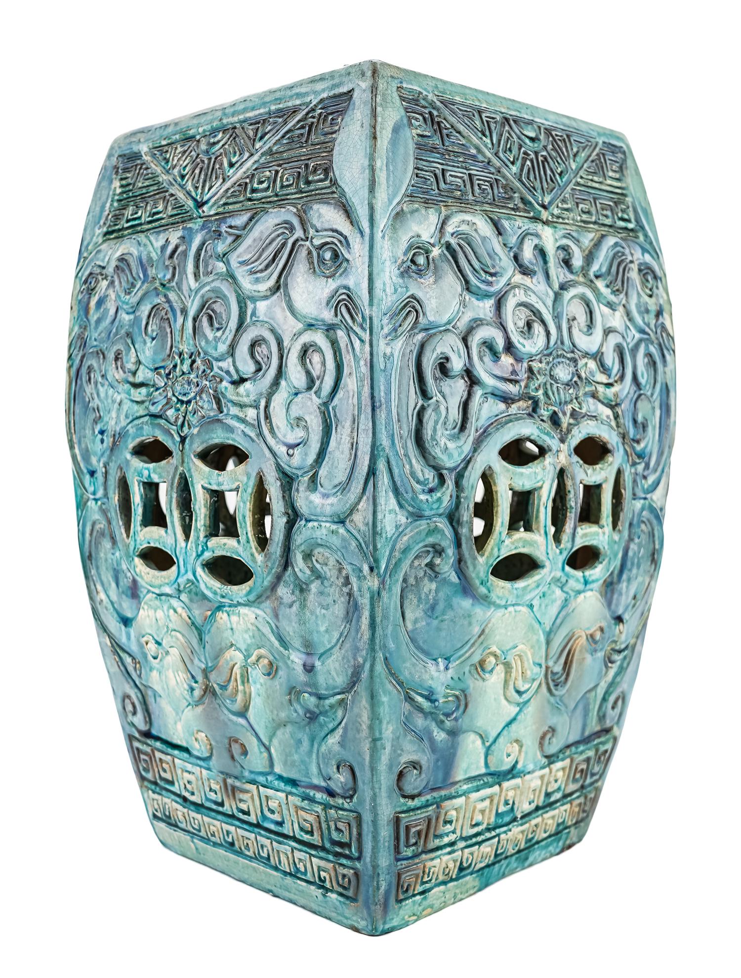 Chinese Pottery Garden Seat: Chinese school earthenware garden seat with blue majolica glaze, relief design of elephants, double coins, lotus. 11"x11"x18.5"