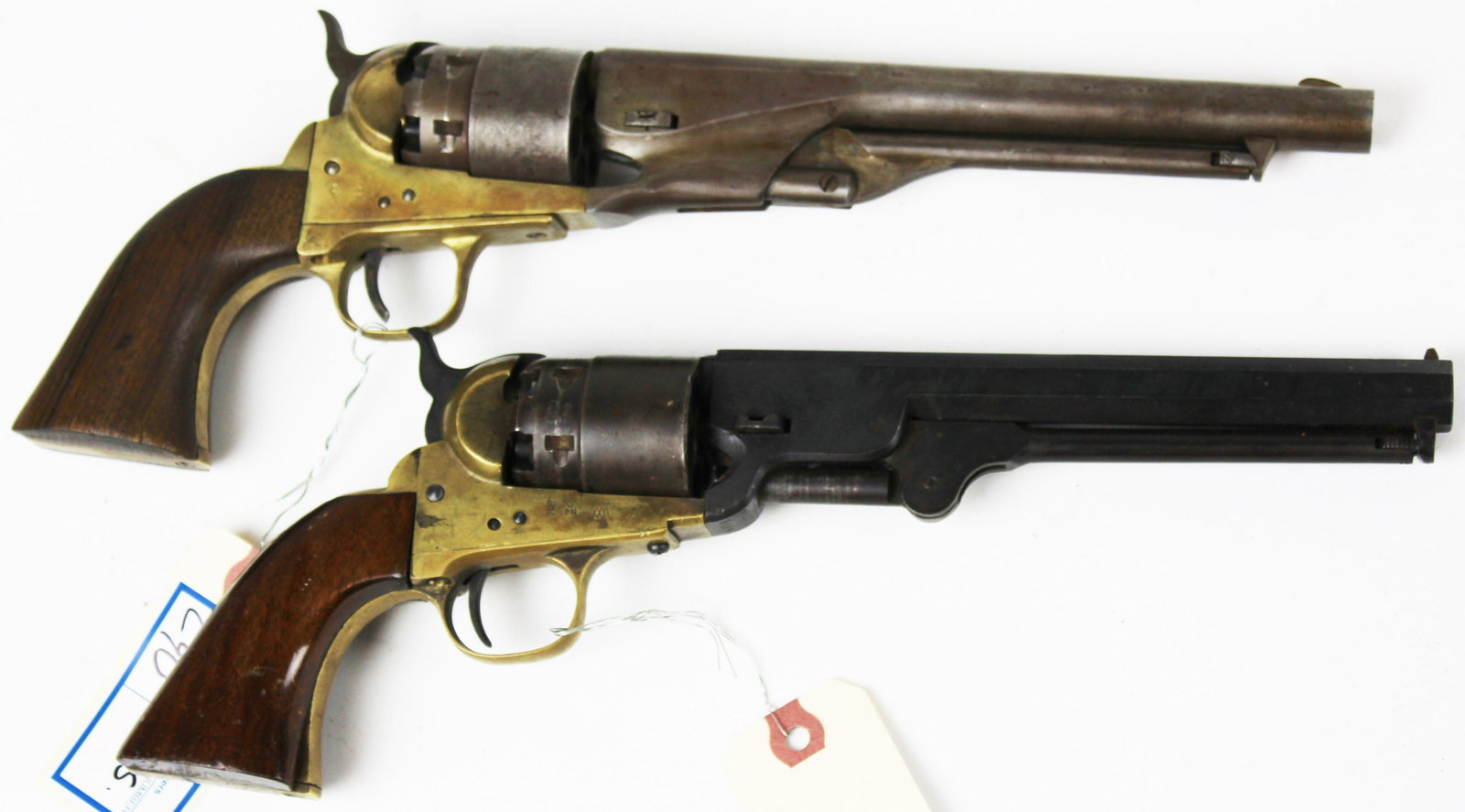Two Reproduction Colt Pistols: Two Reproduction Colt Pistols, One CVA revolver in the style of a Colt Army M.1860 , One in the style of Colt Navy (has chip on one scale and minor dings) WE DO NOT SELL ANY FIREARMS OUTSIDE OF THE US