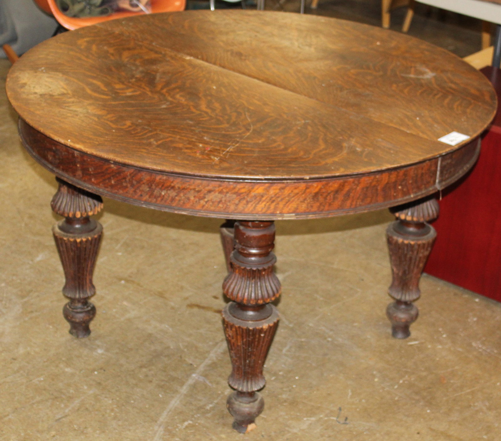 Round Oak Reeded Leg Dining Table: ca. 1890 round quartersawn oak extension dining table with 5 turned and reeded legs, in original finish 27.5" x 45" -some losses to feet, wear to finish