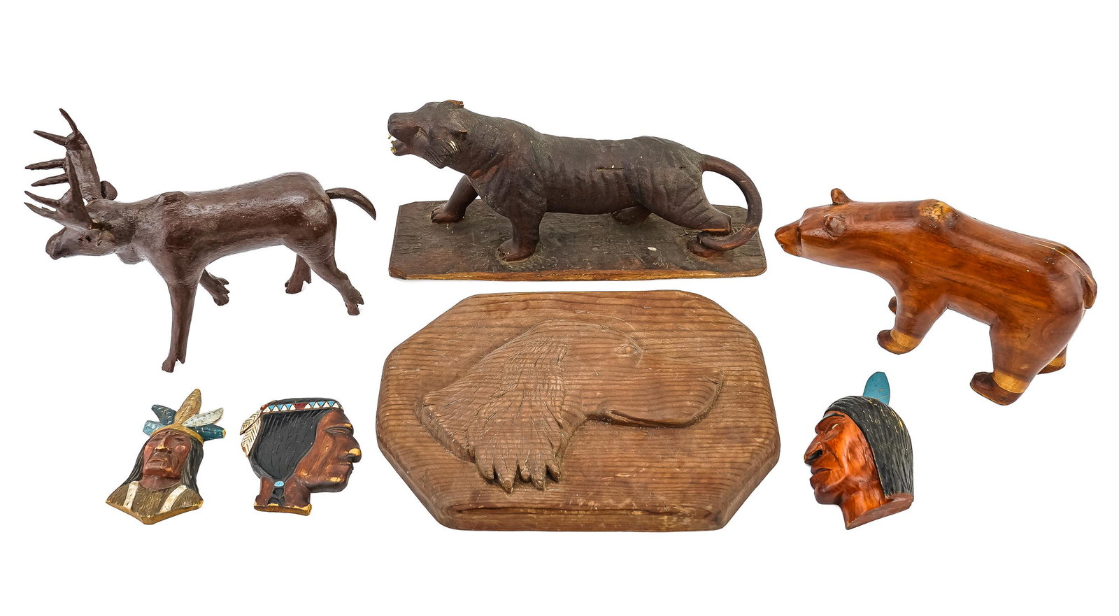 A Group of Folk Art Carvings: A group of 7 various 20thc folk art carvings including a moose 10", bear 9", mountain lion 12", dog silhouette 13", and 3 native silhouettes.