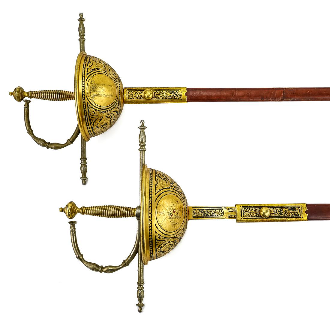 Pair 20th s Toledo Spain Swords: Pair of 20th c gilt Toledo Spain rapier swords. Leather scabbards. 42" long. One scabbard missing gilt end cap.