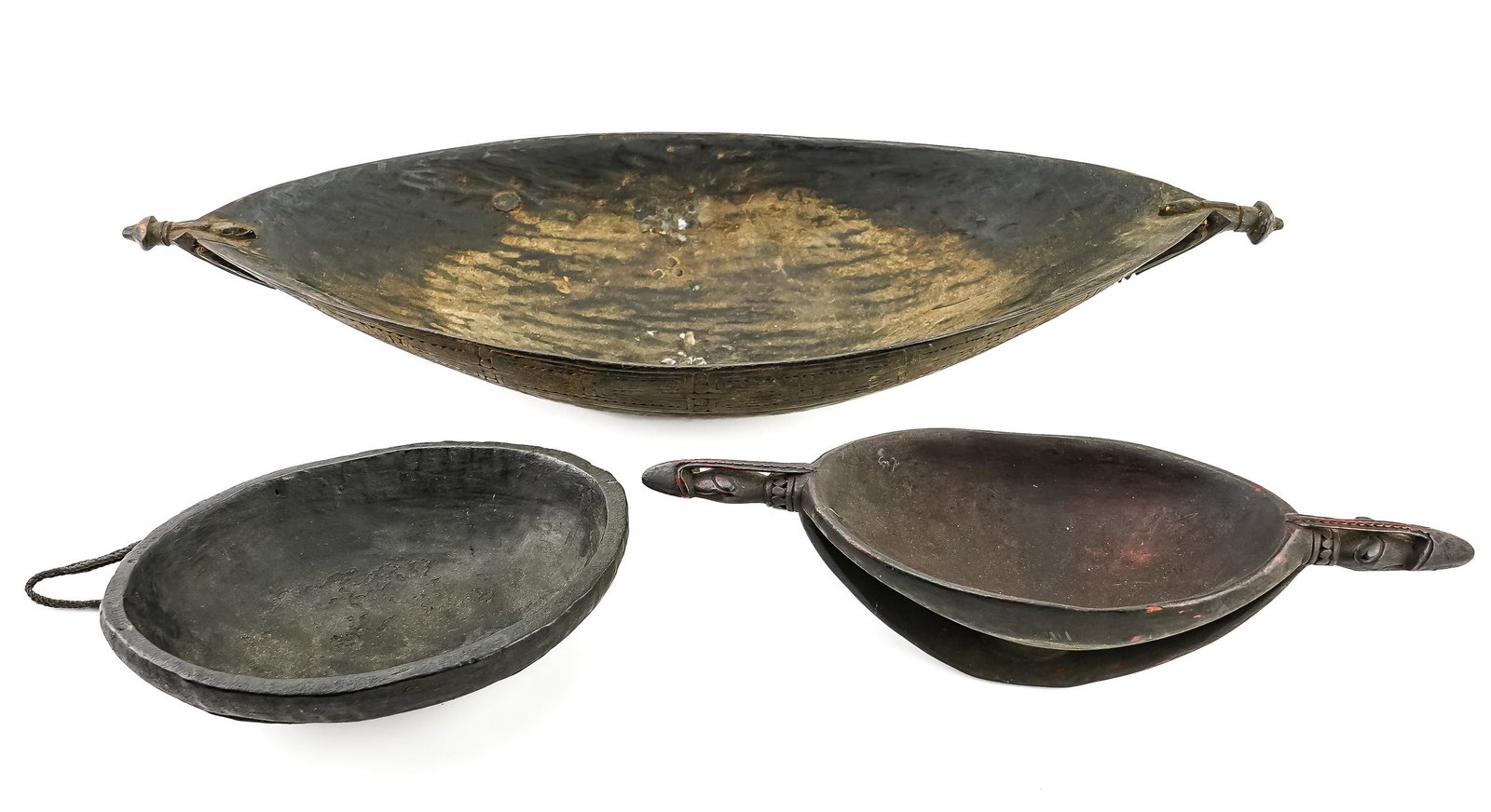 Three Old Papua New Guinea Bowls: Three old wooden carved bowls from Papua New Guinea. One Boiken bowl with relief of lizard, woven fiber strap; one fine Sepik ceremonial bowl with zoomorphic handles, support arches; one large Shouten
