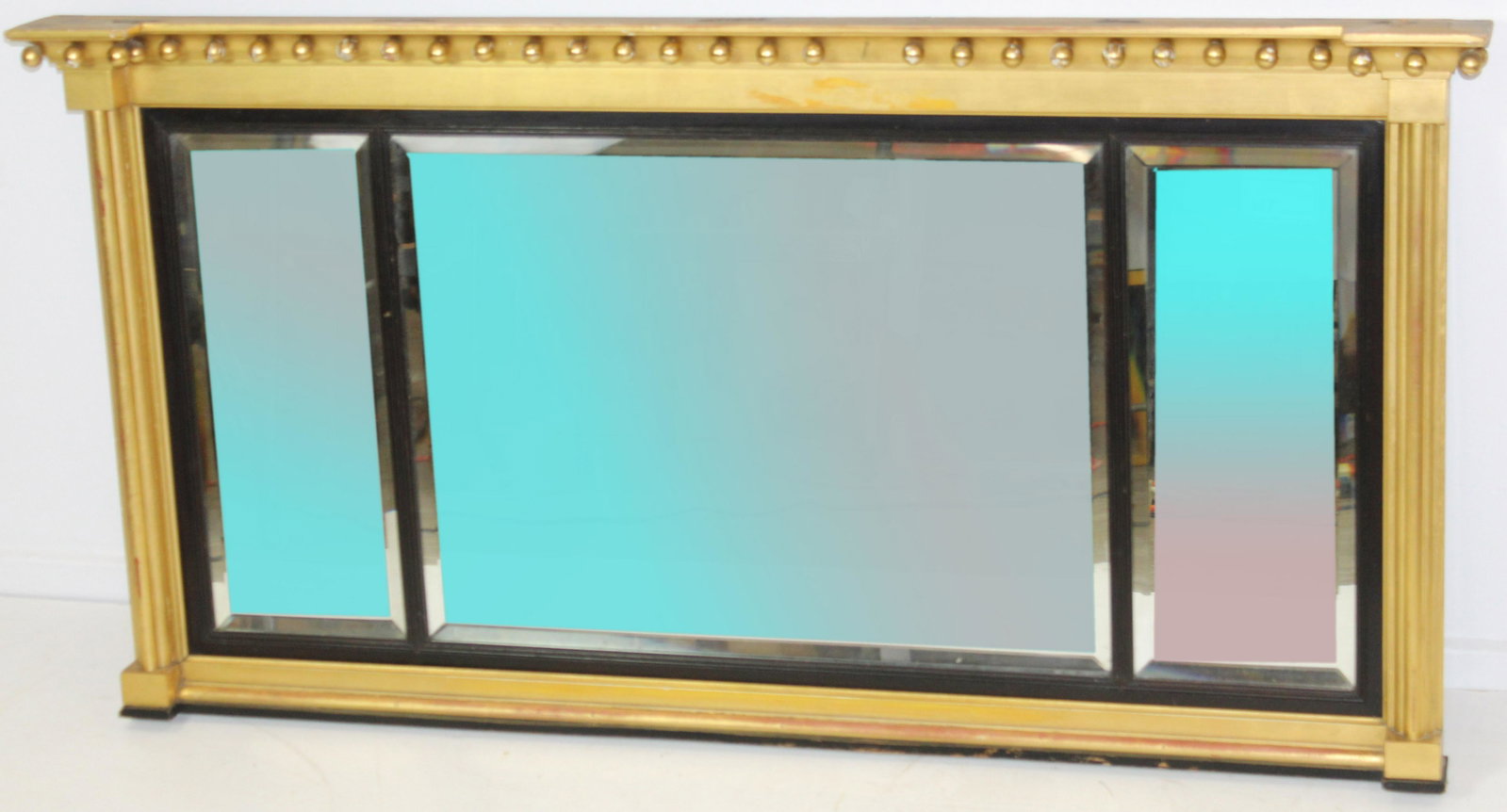 Sheraton Style Overmantle Miirror: Sheraton style lemon gilt overmantle mirror with three beveled plate glass sections, one gilt ball missing, 26" x 51"