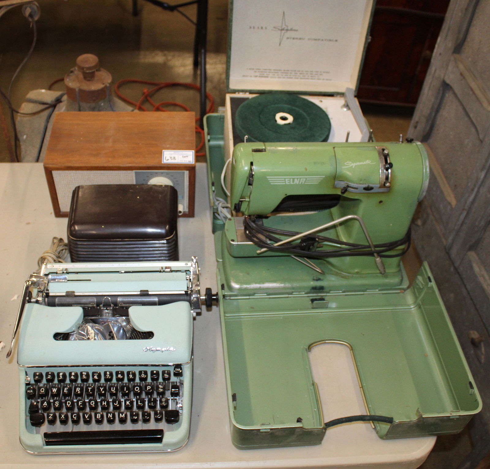 Elna Sewing Machine, KLH Radio, Etc: Estate lot of mid 20th c. vintage home appliances including KLH walnut case radio, Firestone Air Chief bakelite case radio, Elna Supermatic free arm portable sewing machine, Silvertone portable Hi-Fi
