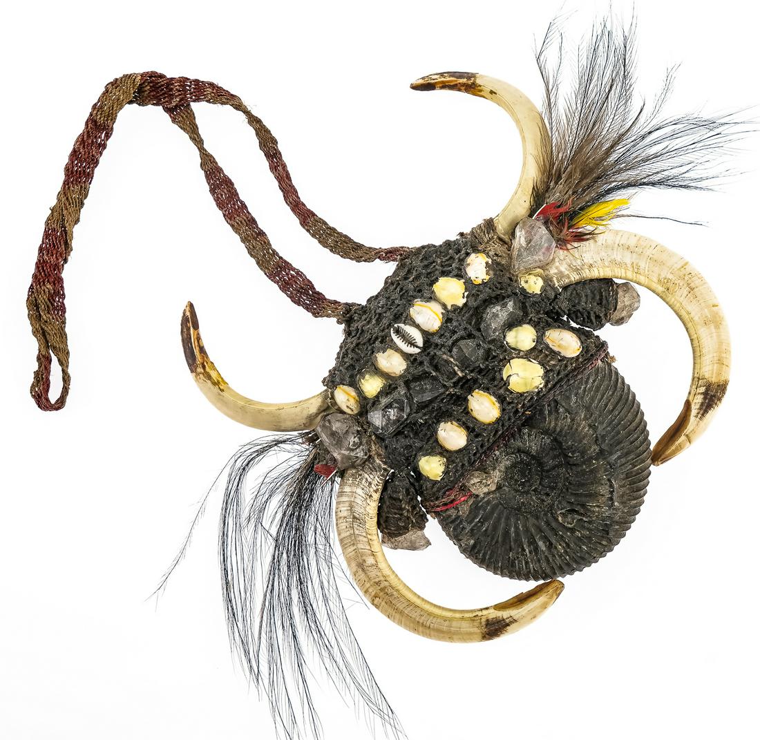 Asmat Ammonite Necklace: Interesting woven Asmat chest ornament from Papua New Guinea, made from Ammonite fossil, tusk, glass, feathers, cowrie shell. Mid 20th century.