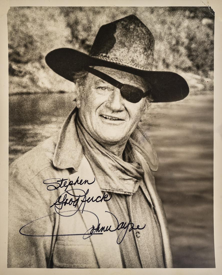 John Wayne Inscribed Photo: John Wayne inscribed publicity photo as Rooster Cogburn (1968 True Grit, 1975 Rooster Cogburn), small tear & crease in top right corner,8" x 10" b&w, Sharpie signature