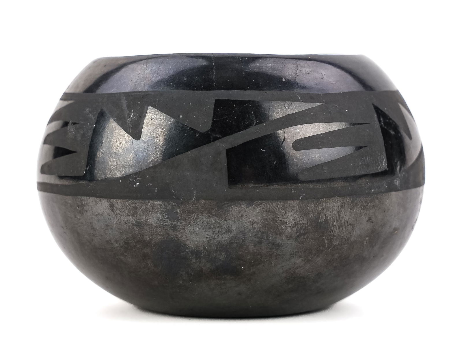 Maria and Julian Martinez San Ildefonso Blackware Pot: Maria Martinez (NM 1882-1980) & Julian Martinez (NM 1879-1943) San Ildefonso Pueblo black on black pottery vessel with geometric feather design. Signed "Marie + Julian" on base, indicating pre - 1943