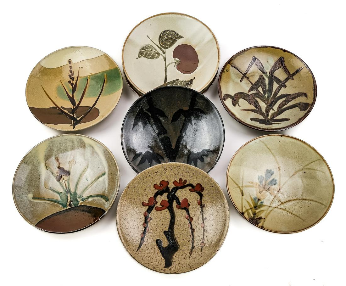 Set of 8 Japanese Mashiko pottery plates: Set of 8 Mashiko ware art pottery plates with various slip decoration. 11" diameter.