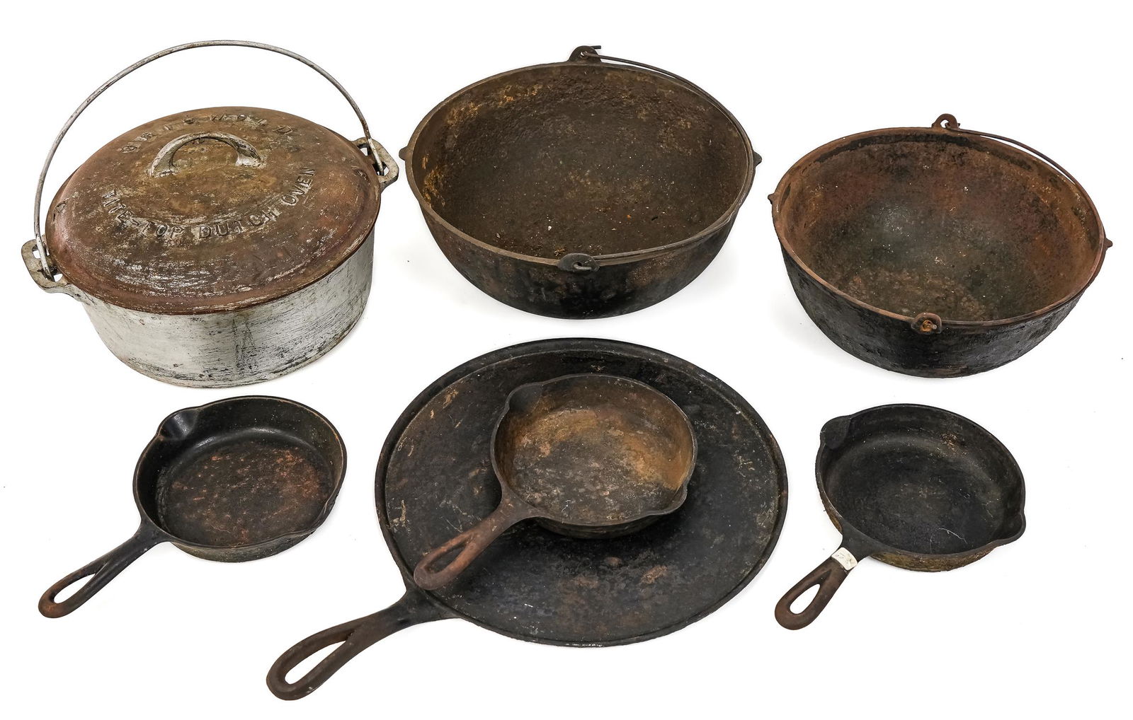 Large Block Griswold and Assorted Cast Iron: Lot includes three #3 Griswold skillets,Griswold #9 Tite-top dutch oven, two unmarked cauldrons, one unmarked griddle. Rusting, wear, pitting present.