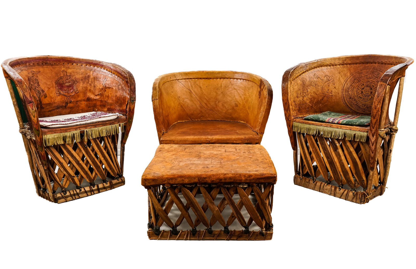 Mexican Equipale barrel back chairs: Three Mexican Equipale barrel back chairs made of leather and indigenous woods, one matching ottoman or stool, two chairs decorated with pyrographic scenes including folk dancers and Aztec motifs. Cha