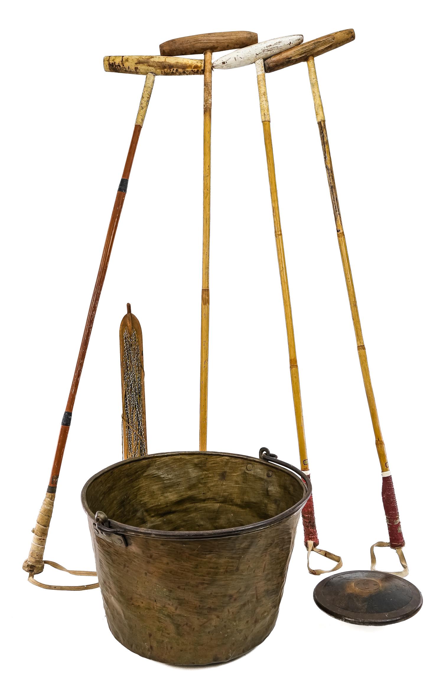 Lot of Antique Sporting Equipment: Lot consists of Four wooden polo mallets with bamboo handles, wooden fishing jig, and a Spaulding wood and iron ringed discus. 51"-52", 26.5", 9"D. Comes in copper bucket, 17.5Dx12"