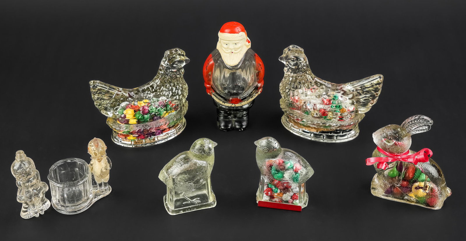 Group of 6 Figural Glass Candy Containers: Group of 6 figural glass candy containers including two hens on nests, unusual Santa Claus with paint decorated elements, two chicks and bunny rabbit, accompanied by a Kewpie type toothpick holder, an