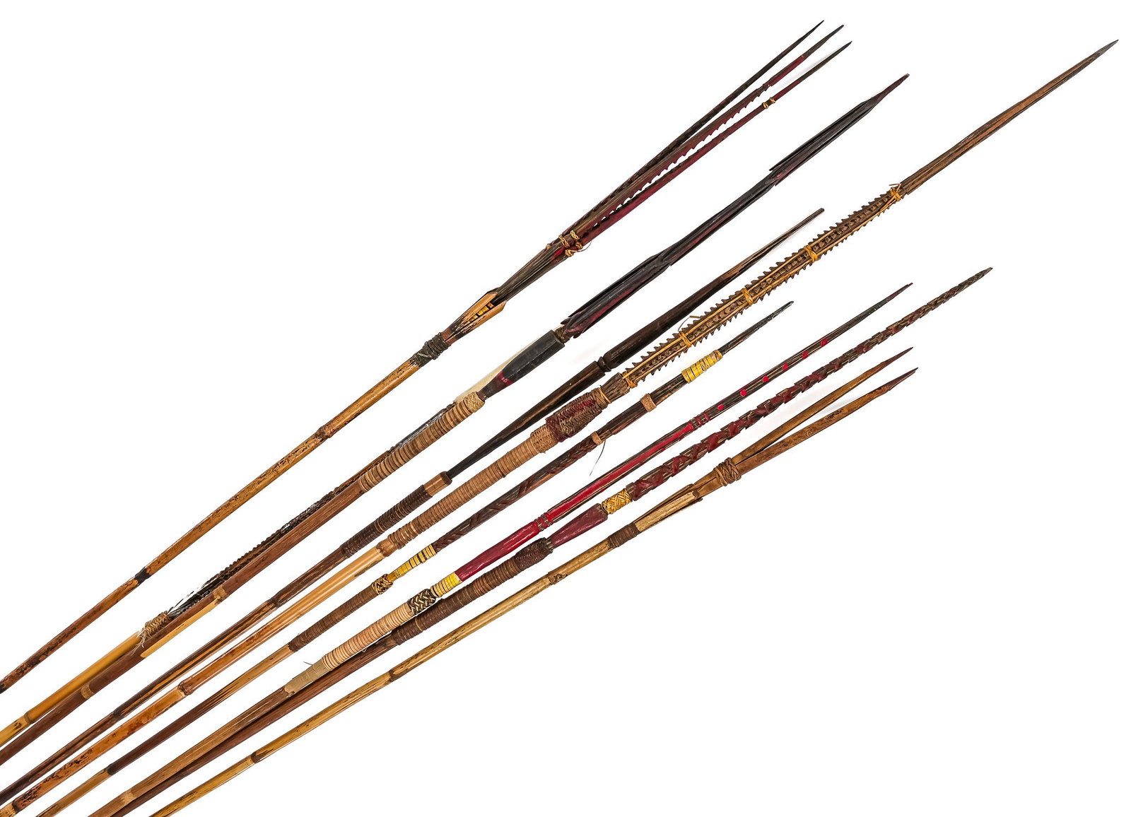 Nine Papua New Guinea Bamboo Arrows: Nine arrows from Papua New Guinea with bamboo shafts, wooden tips lashed in, one has a bone arrowhead. Varying designs for hunting, fishing, and warfare. 44.5"-52"