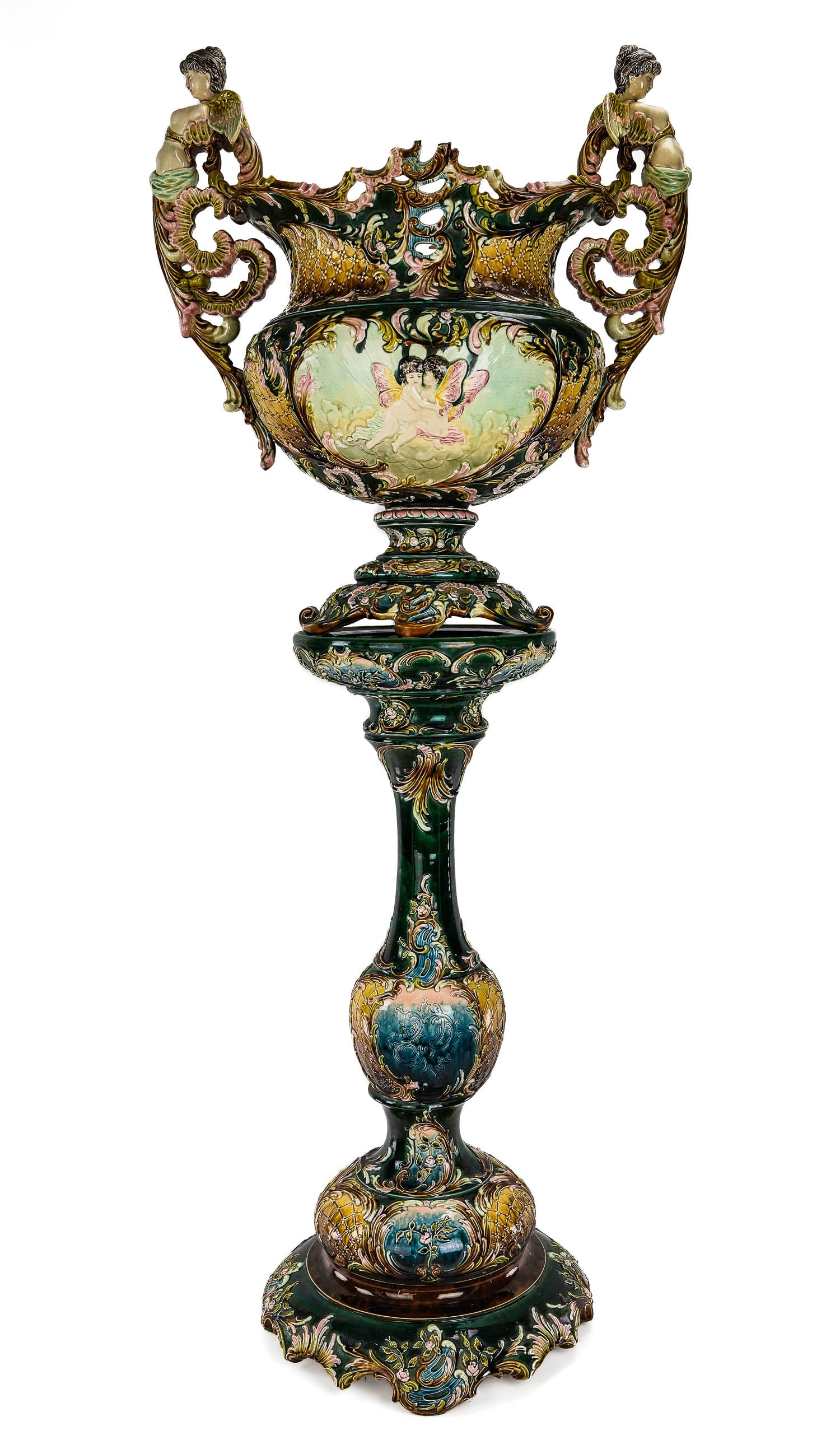 19th c. Austrian Majolica Jardiniere on Stand: Monumental late 19th or early 20th century Austrian colorful polychrome decorated majolica glazed pottery jardiniere on stand with winged female nude figural handles and embossed rococo decoration, ro