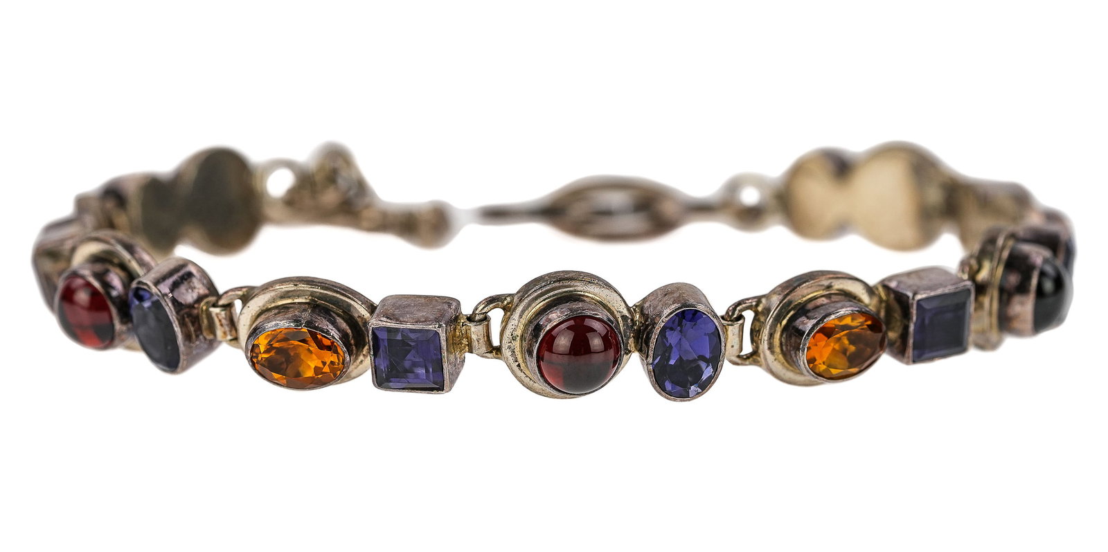Sterling & Semi-Precious Bracelet: Sterling bracelet with multiple bezel set stones including garnets, citrine, & tanzanite. 8" long.
