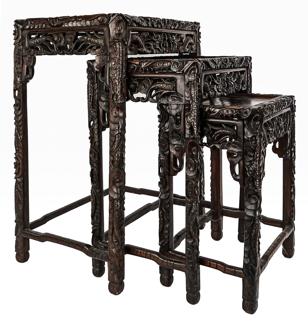 Chinese Dragon Carved Nesting Tables: A set of 3 ca. 1900 Chinese hardwood carved nesting with open work dragon carving and overall dragon design. 17" x 12" x 24" h (largest). Overall good condition and older mellow surface.