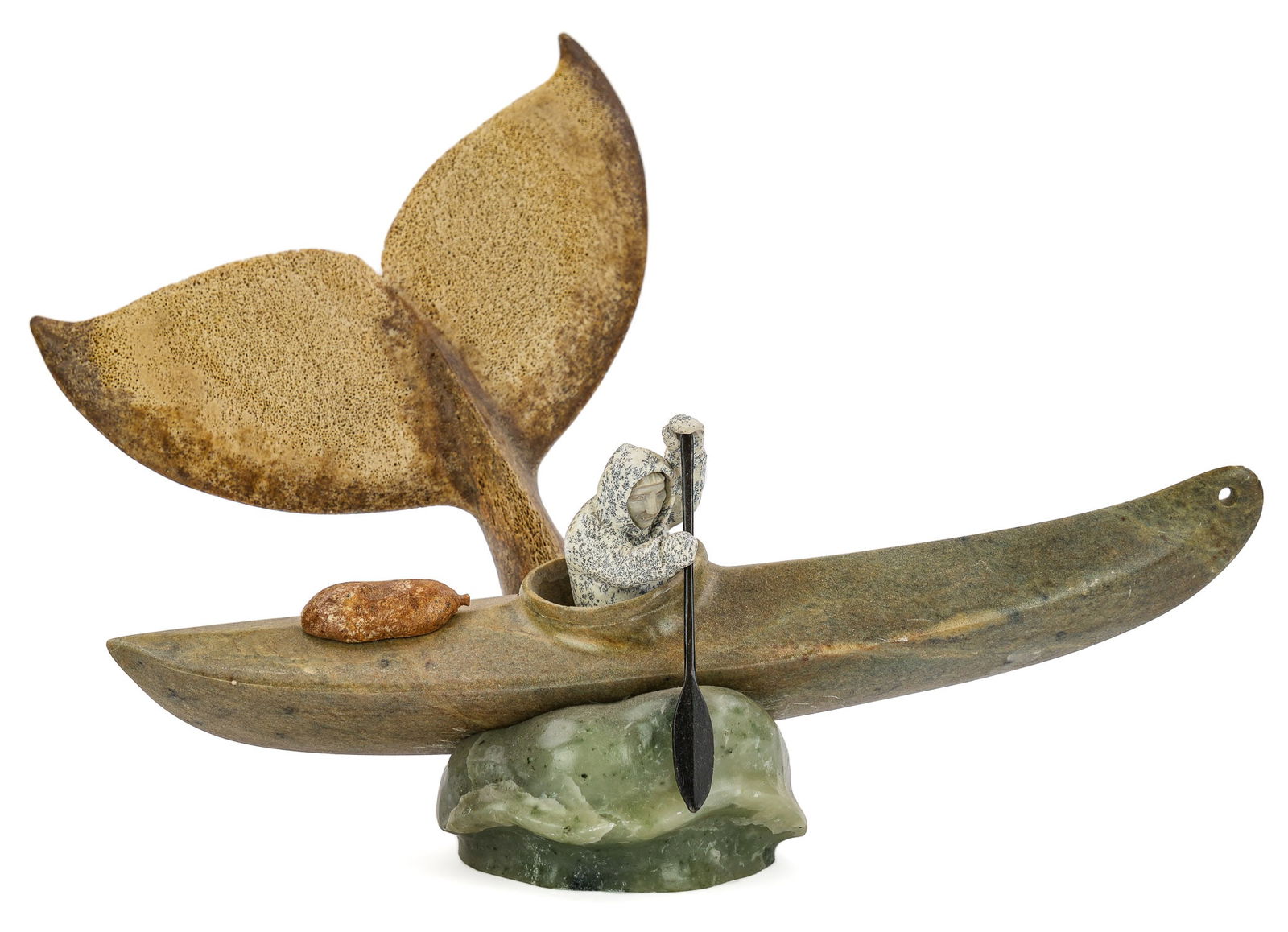 Inuit Soapstone & Bone Carving of Man, Boat, & Whale.: Fine multi-color soapstone and bone 20th c Inuit carving of a man in Umiak and whales tail carved from bone rising behind boat. 9" h. 13" l. Good condition.