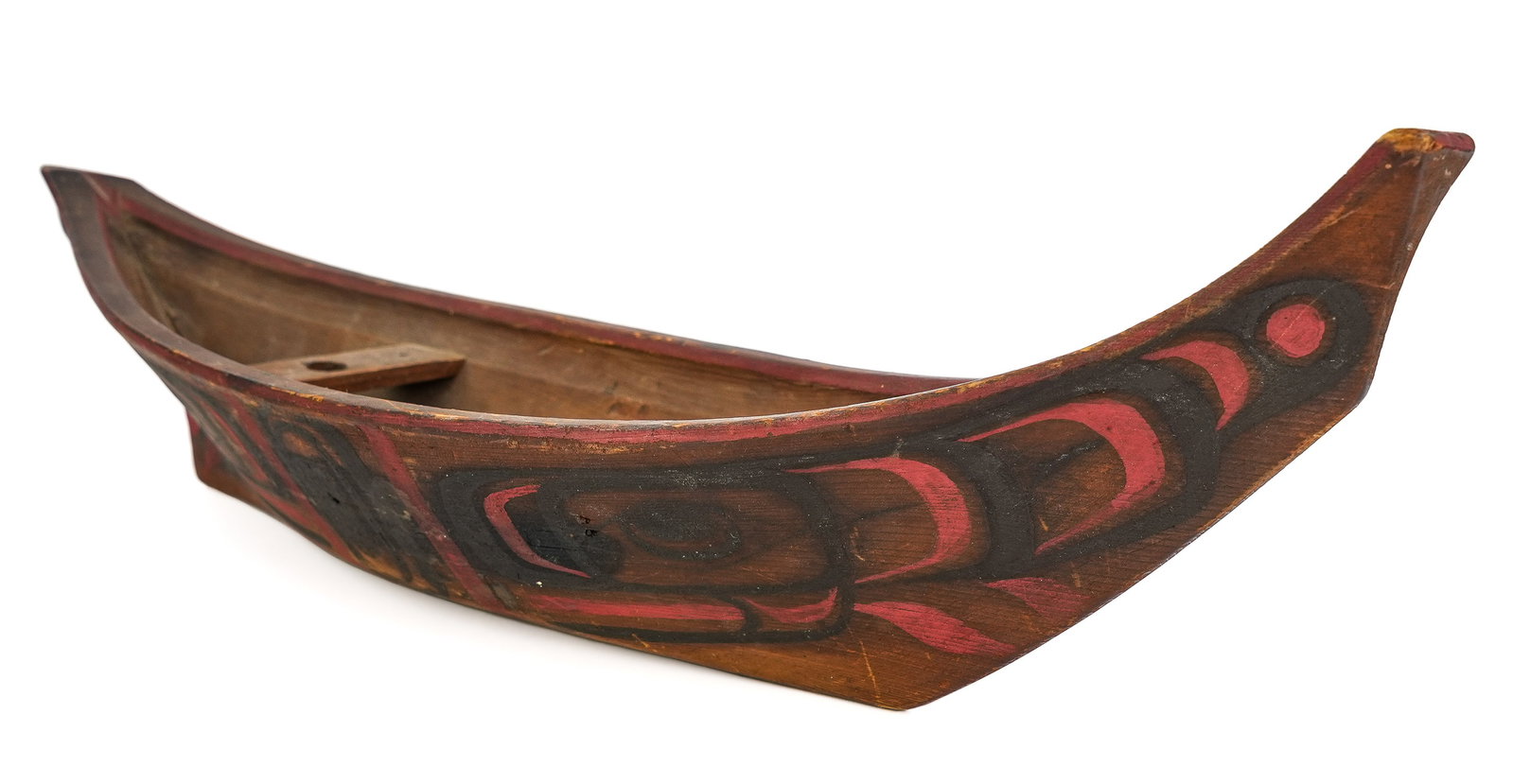 Tlingit Pacific Northwest Carved Wooden Boat: Late 19th c / Early 20th c Tlingit Pacific Northwest carved and polychrome decorated boat, wooden pegs holding seats, damage to prow, length 17 1/2"