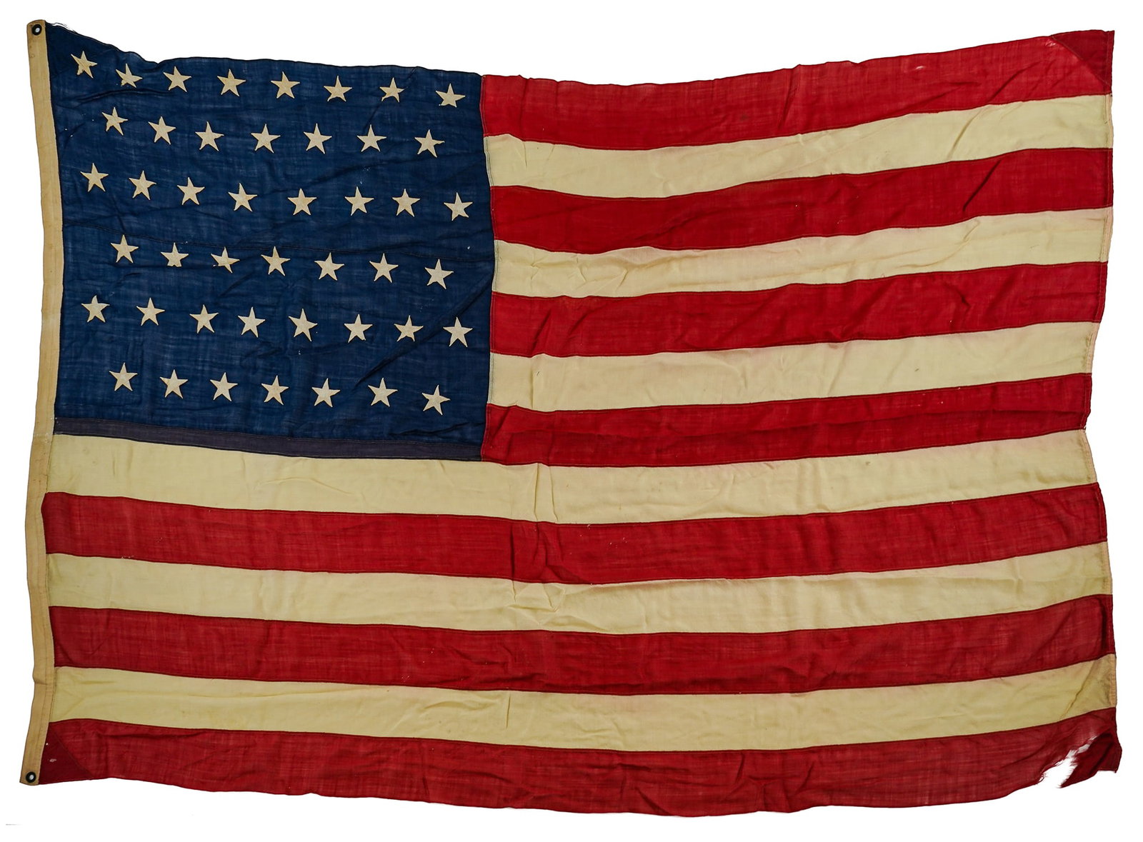 1896 45 Star US Flag (Utah): 1896 machine stitched US Flag with 8/7 Alternating row canton, minor tears and losses commensurate with age, additional material sewn in canton and original reinforcements at corners on hanging edge -
