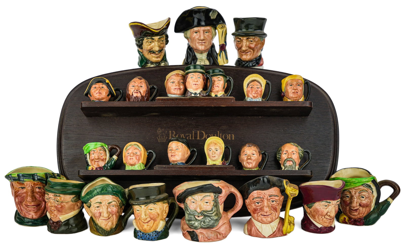 24 Royal Doulton Miniature Porcelain Toby Jugs: Collection of 25 Royal Doulton English porcelain miniature character face toby jugs including many Charles Dickens literary figures with wooden display rack, accompanied by one Lancaster ht. 1.5"-3", 