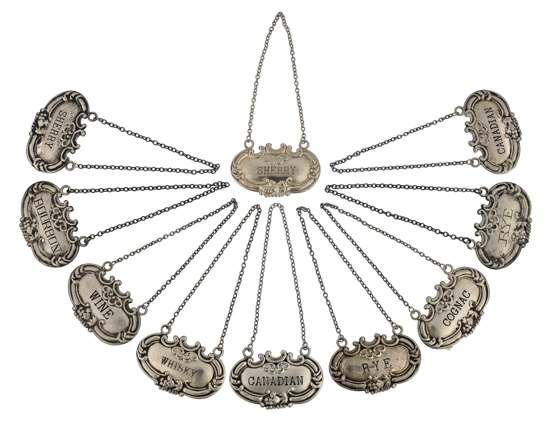 Set of 10 Sterling Silver Liquor Decanter Tags: Set of 10 Rococo style sterling silver liquor decanter label tags including cognac, bourbon, whisky, rye, wine, Canadian, and sherry 1" x 2" 2.73 troy oz.